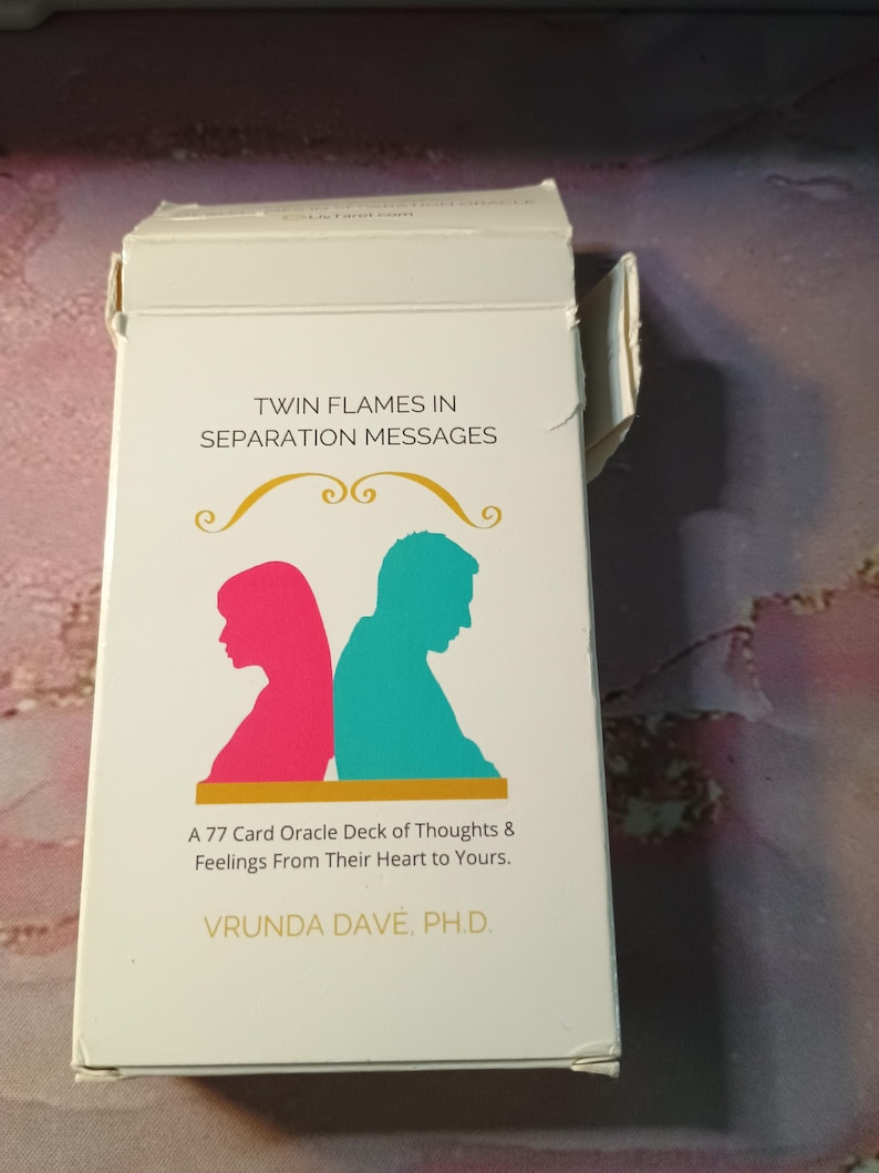 May include: A white box with a gold border and the text "Twin Flames in Separation Messages" on the front. The box contains a 77-card oracle deck of thoughts and feelings from their heart to yours. The box is designed by Vrunda Dave, Ph.D.