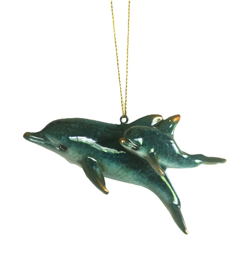 Bring a touch of the ocean into your home with this beautifully crafted set of 2 dolphin ornaments