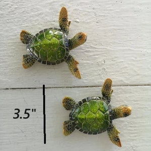 A majestic green sea turtle gracefully swimming through clear ocean waters. The turtle's shell is a rich shade of green with captivating patterns, and its flippers propel it with elegance