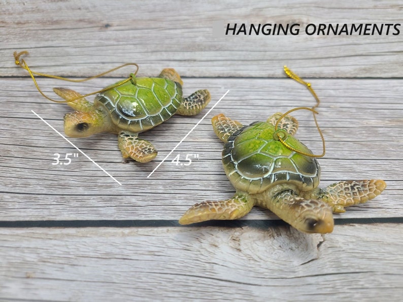 A beautifully crafted green sea turtle ornament made of glass, featuring lifelike details of the turtle's shell and flippers. The ornament showcases shades of vibrant green, with intricate patterns on its shell. Suspended by a silver thread