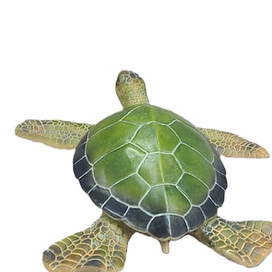 Majestic turtle figurine exuding a sense of grandeur and charm. The intricate details showcase the graceful curves and patterns on the shell, while the subdued yet rich color palette adds a touch of elegance