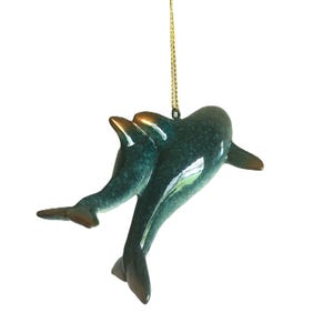Bring a touch of the ocean into your home with this beautifully crafted set of 2 dolphin ornaments