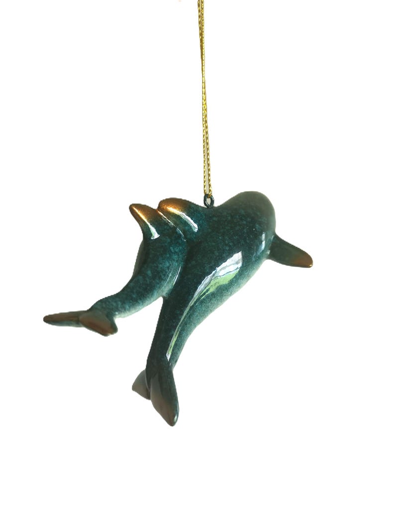 Bring a touch of the ocean into your home with this beautifully crafted set of 2 dolphin ornaments