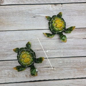 An adorable cartoon sea turtle with a vibrant green shell and expressive eyes. The turtle is depicted with a friendly smile and has whimsical details