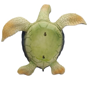 Majestic turtle figurine exuding a sense of grandeur and charm. The intricate details showcase the graceful curves and patterns on the shell, while the subdued yet rich color palette adds a touch of elegance