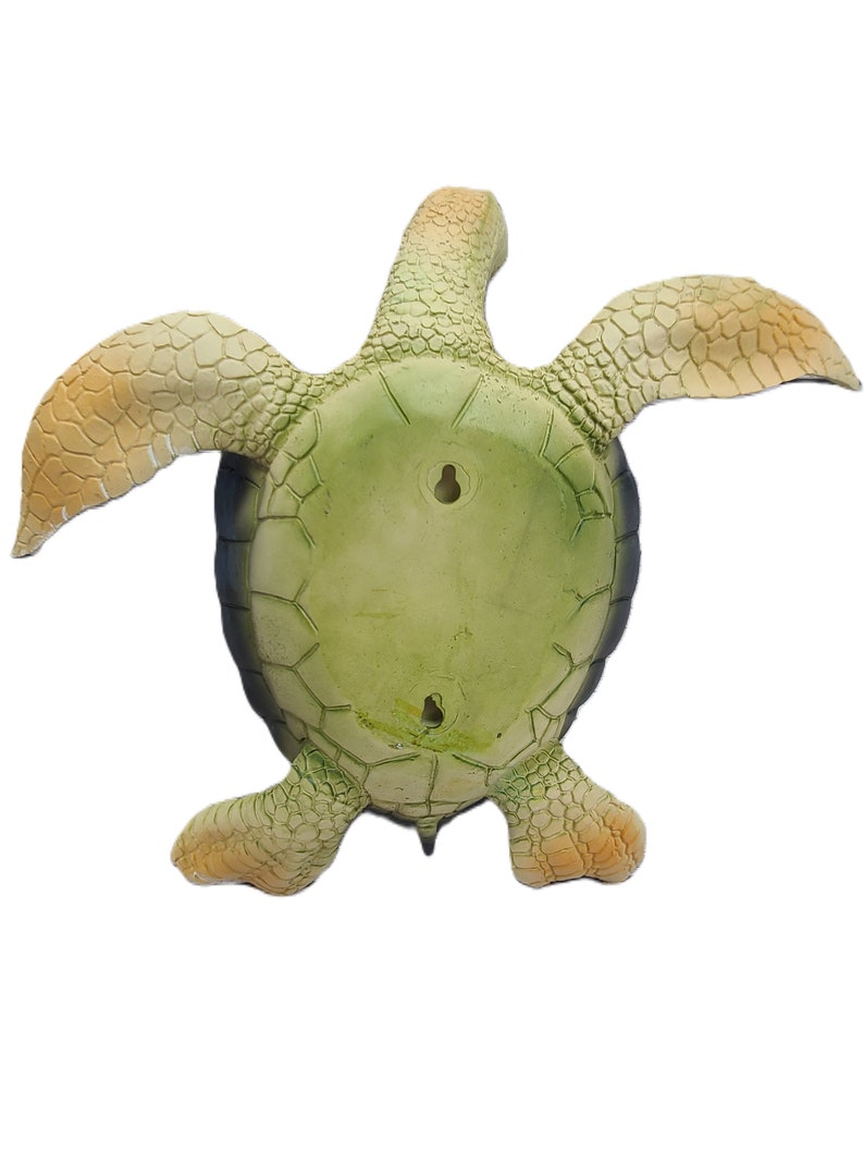 Majestic turtle figurine exuding a sense of grandeur and charm. The intricate details showcase the graceful curves and patterns on the shell, while the subdued yet rich color palette adds a touch of elegance