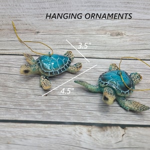 A handcrafted sea turtle ornament, made of polystone featuring intricate details of the turtle's shell and flippers. The ornament is predominantly blue with subtle blue accents, capturing the essence of the ocean.