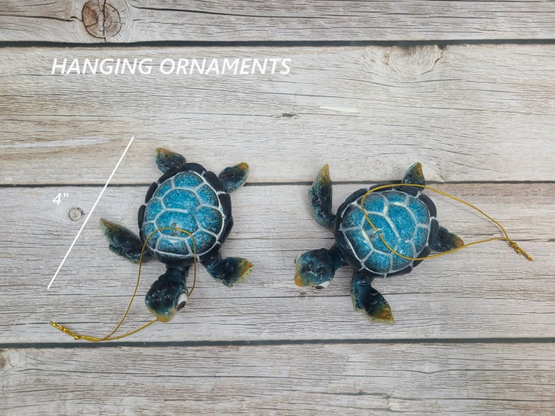 A whimsical blue cartoon turtle ornament, featuring a delightful design with a vibrant blue shell and expressive eyes. The ornament is adorned with playful details, bringing a sense of charm and joy