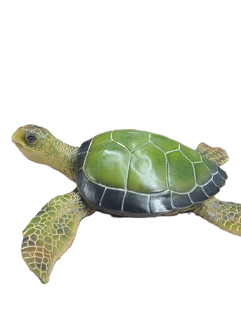 Majestic turtle figurine exuding a sense of grandeur and charm. The intricate details showcase the graceful curves and patterns on the shell, while the subdued yet rich color palette adds a touch of elegance