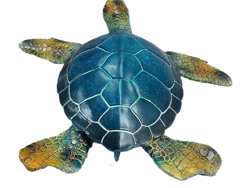 Elegant sea turtle figurine with lifelike details and a serene pose. The intricate patterns on the shell and the subdued color palette capture the beauty of this marine creature. Perfect for adding a touch of oceanic charm to your decor