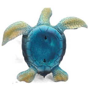Elegant sea turtle figurine with lifelike details and a serene pose. The intricate patterns on the shell and the subdued color palette capture the beauty of this marine creature. Perfect for adding a touch of oceanic charm to your decor