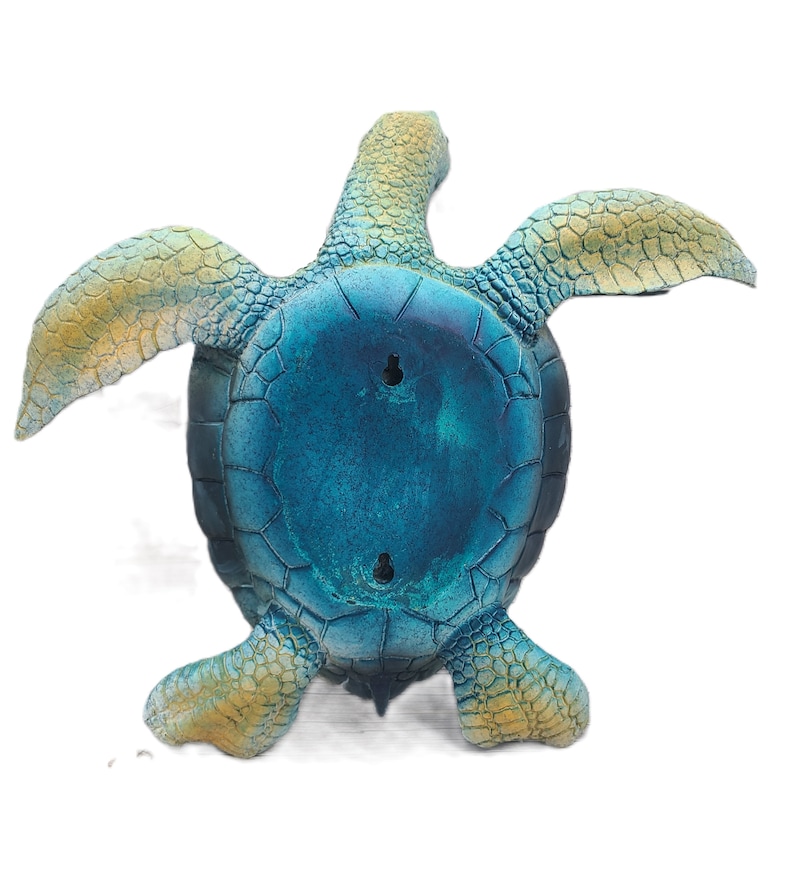 Elegant sea turtle figurine with lifelike details and a serene pose. The intricate patterns on the shell and the subdued color palette capture the beauty of this marine creature. Perfect for adding a touch of oceanic charm to your decor