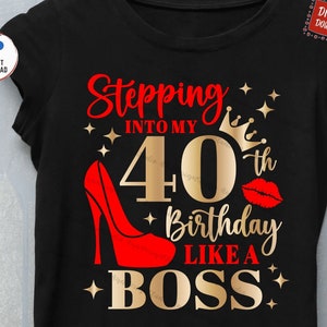 May include: A black t-shirt with gold text that says "Stepping into my 40th Birthday Like a Boss". The text is surrounded by gold stars and a gold crown. There is a red high heel shoe and a red lipstick kiss mark on the shirt.
