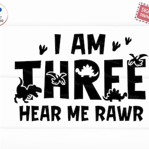 May include: Black and white graphic design with the text "I am three hear me rawr". The graphic features a dinosaur footprint, a dinosaur, and the number three.