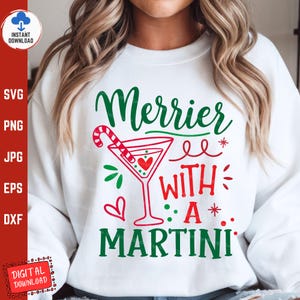 May include: White sweatshirt with a green and red graphic that says "Merrier with a Martini" and includes a martini glass with a candy cane.
