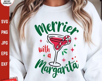 May include: White sweatshirt with green text that says "Merrier with a Margarita" and a red margarita glass with a candy cane in it.