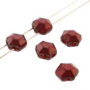 May include: Five dark red faceted glass beads, each with a hexagonal shape.