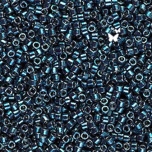 May include: A close-up view of a large quantity of dark blue seed beads. The beads are small and round with a metallic sheen.