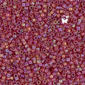 May include: A close-up image of a large quantity of small, round, iridescent beads. The beads are a mix of purple and gold colors.