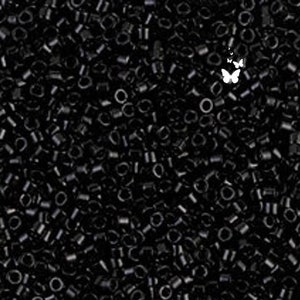 May include: A close-up image of a large quantity of small, black, plastic beads. The beads are all the same size and shape, and they are arranged in a random pattern.