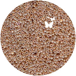 May include: A close-up view of a large quantity of small, round, iridescent seed beads in a light peach color.