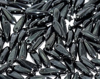 May include: A large quantity of black glass teardrop beads with a glossy finish.