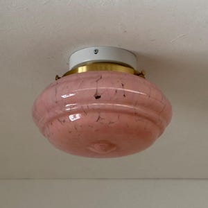 May include: A rustic wooden sign with the text "Welcome to our home" in white lettering. The sign features a distressed finish and a simple, inviting design, perfect for entryway decor.