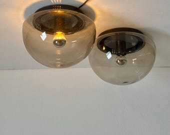 May include: Two brown glass globe ceiling lights with black metal fixtures.