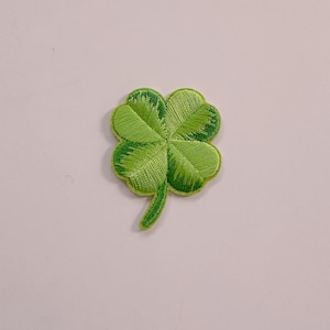 May include: A green four-leaf clover embroidered patch.