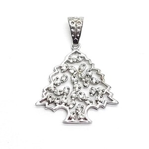 May include: A silver-toned metal pendant shaped like a stylized cedar tree. The openwork design features a series of small, clear, faceted stones embedded throughout the branches, with a textured, patterned bail at the top for attachment.