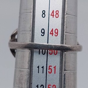 May include: A silver ring sizing tool with numbers 7 through 12 and corresponding sizes 47 through 52.