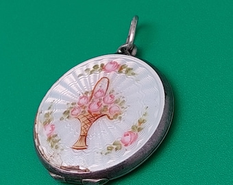May include: A silver locket with a white enamel background and a hand-painted design of a basket of pink roses.