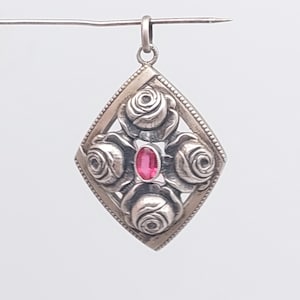 Antique Art Nouveau silver rose pendant with red cut stone