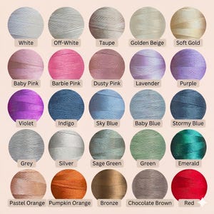 May include: A collection of colorful embroidery thread spools, each labeled with a color name. Colors include white, pinks, blues, greens, and oranges. The spools are arranged in rows, showcasing a wide range of shades and hues for crafting projects.