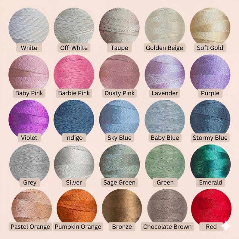 May include: A collection of colorful embroidery thread spools, each labeled with a color name. Colors include white, pinks, blues, greens, and oranges. The spools are arranged in rows, showcasing a wide range of shades and hues for crafting projects.