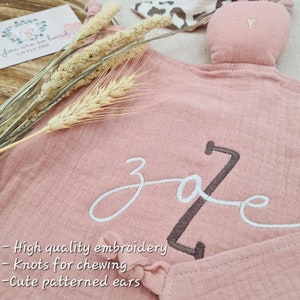 Warm pink baby comforter blanket with embroidered baby name and animal print ear pattern