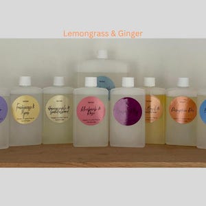 May include: Ten clear glass bottles with labels and different scents. The labels have a circle with the scent name in black script. The scents are Lavender,  Frankincense & Myrrh,  Honeycrisp & Green Almond,  Rhubarb & Rose,  Lemongrass & Ginger,  Beach & Watermelon,  Pumpkin Pie,  Big Curl & Coconut.