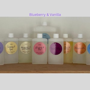 May include: Ten clear glass bottles with gold lids and labels. Each bottle has a different scent, including Lavender, Frankincense & Myrrh, Honeycrisp & Green Almond, Blackberry & Rose, Blueberry & Vanilla, Peach & Nectarine, Pumpkin Pie, Big Curl & Coconut.