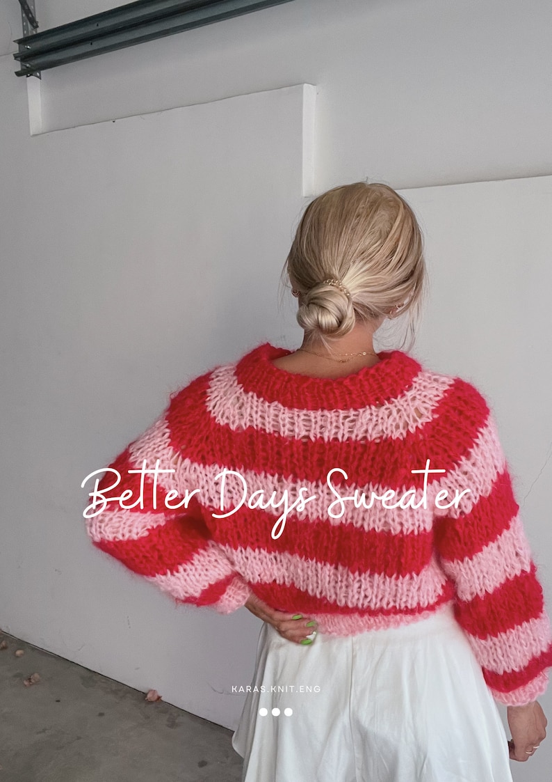 May include: A pink and red striped knit sweater with the text "Better Days Sweater" on the back. The sweater is cropped and has a loose fit.