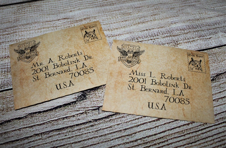 May include: Two vintage-style envelopes with a brown paper texture. Each envelope has a stamp with an owl and the text "Owl Post" and "Post Service". The envelopes are addressed to Mr. A. Roberts and Miss L. Roberts, both at 2001 Bobolink Dr., St. Bernard, LA 70085, USA.