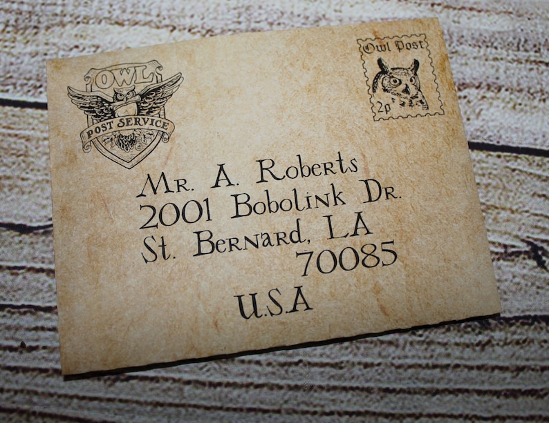 May include: A vintage-style envelope with an owl logo and the text "Owl Post" in the upper right corner. The envelope is addressed to "Mr. A. Roberts, 2001 Bobolink Dr., St. Bernard, LA 70085, USA".