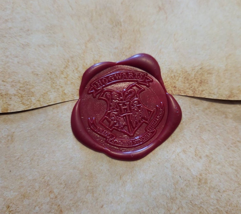 May include: A red wax seal with the Hogwarts crest and the words "Hogwarts School of Witchcraft and Wizardry" around it.