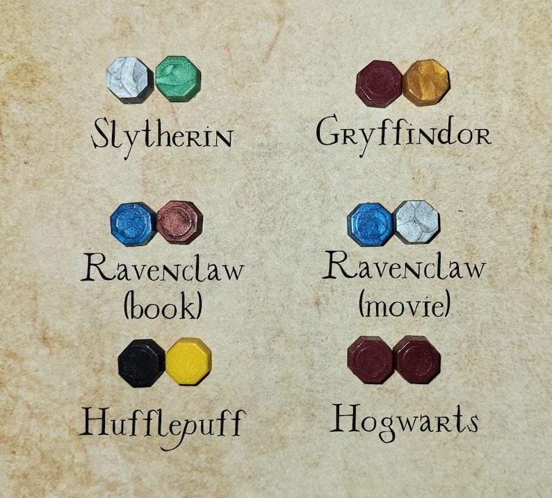 May include: A set of wax seals representing the Hogwarts houses: Slytherin (silver and green), Gryffindor (red and gold), Ravenclaw (blue and silver), Hufflepuff (black and yellow), and Hogwarts (maroon).