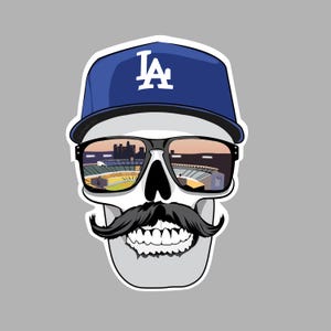 May include: A cartoon skull wearing a blue baseball cap with the letters "LA" on the front. The skull is wearing sunglasses with a reflection of a baseball stadium in the lenses. The skull has a black mustache.