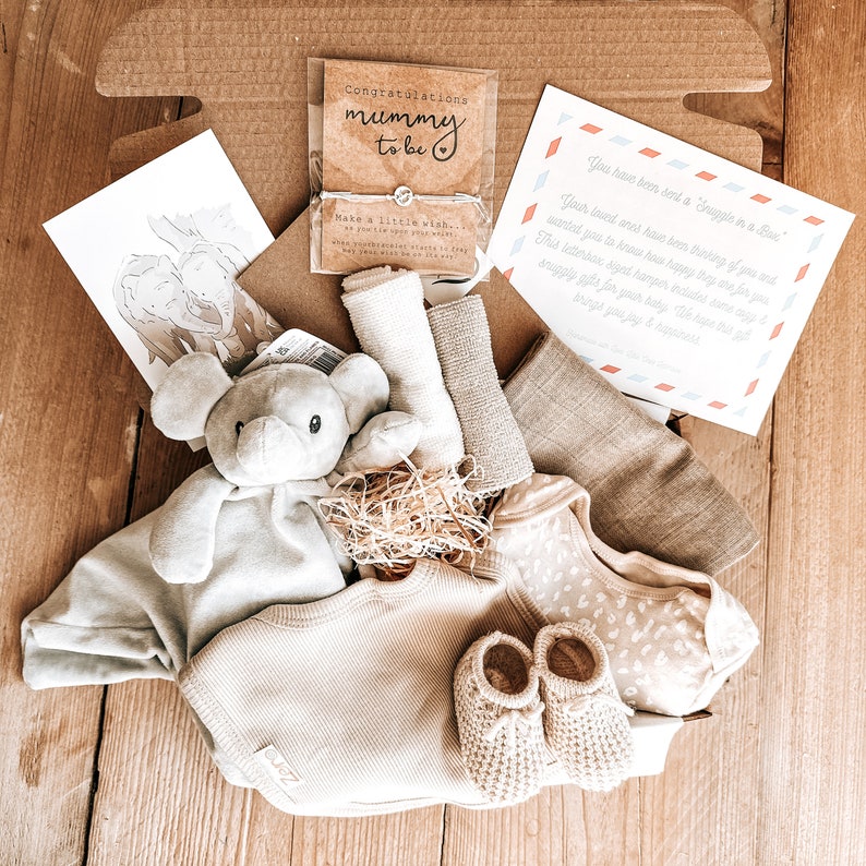 Consciously created, 9 piece new-born baby gift set. Super soft, ECO friendly Elephant Comforter. Baby feet charm bracelet for new mum. Adorable knitted booties. Large cotton muslin blanket, Cotton Bib, Cotton Vest, 2 wash  cloths, +printed gift card