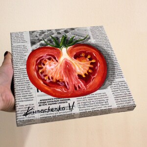 May include: A painting of a red tomato cut in half, with seeds visible, on a newspaper background. The painting is titled "Kumachenko V" and includes the text "Archeologists have unearthed the steps of the Siloam pool, where Jesus healed the blind man."