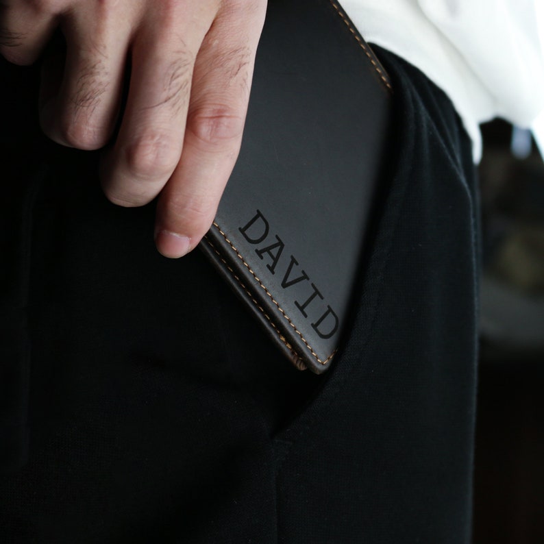 May include: A black leather wallet with the name 'DAVID' embossed in gold lettering.