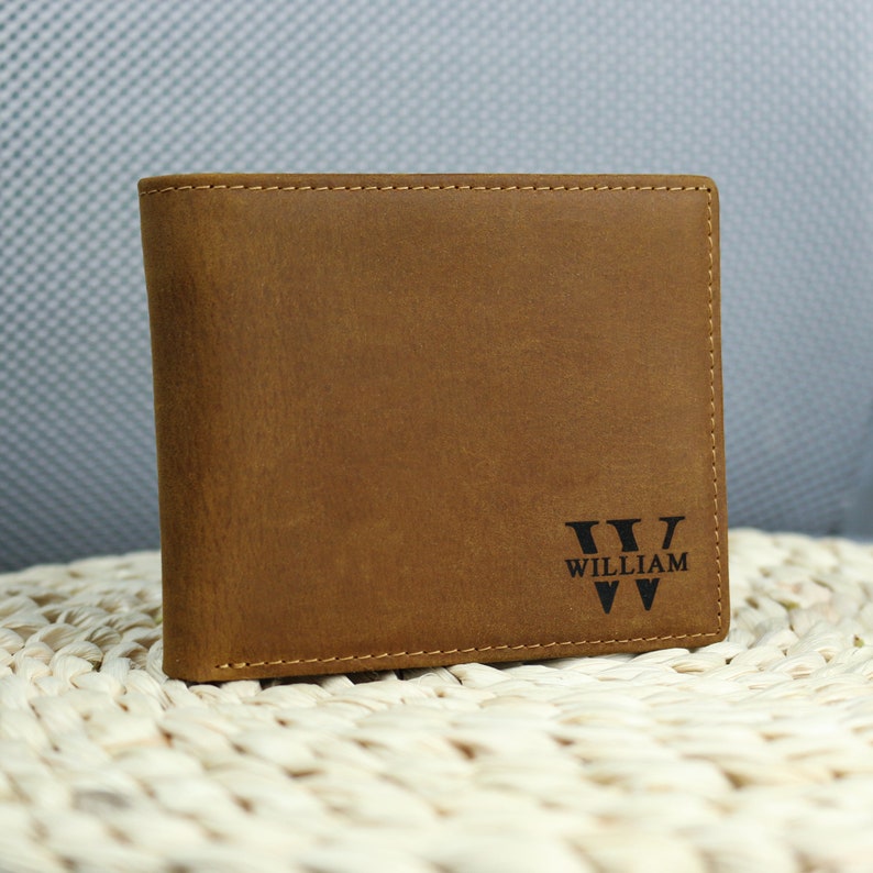 May include: A brown leather wallet with the name 'WILLIAM' and the letter 'W' embossed on the front.