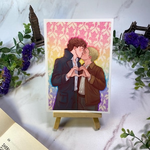 May include: A rectangular art print featuring a digital illustration of two individuals kissing and forming a heart shape with their hands. The background displays a repeating floral pattern in a gradient of pink, yellow, and blue colors.