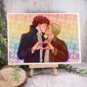 May include: A rectangular art print featuring a digital illustration of two individuals kissing and forming a heart shape with their hands. One individual has dark curly hair and a dark coat, while the other has short blonde hair and a brown jacket.